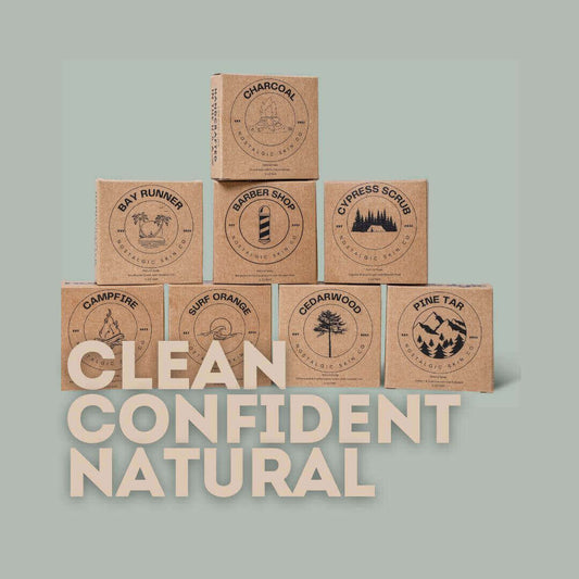 A product showcase featuring 8 eco-friendly, sustainably packaged bar soaps for men, arranged on a natural wood background with minimal decorative elements, emphasizing the brand's commitment to environmentally responsible grooming practices.