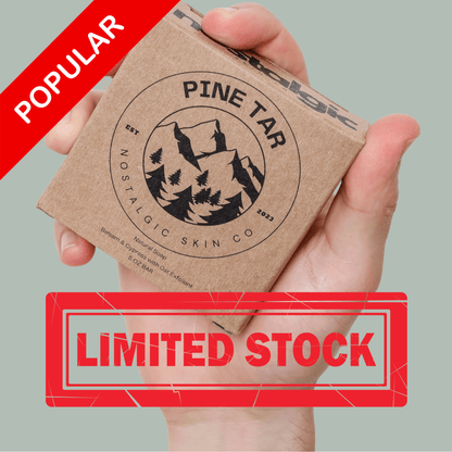 Hand holding Pine Tar Bar Soap package with "Limited Stock" label, promoting natural biodegradable soap for men.