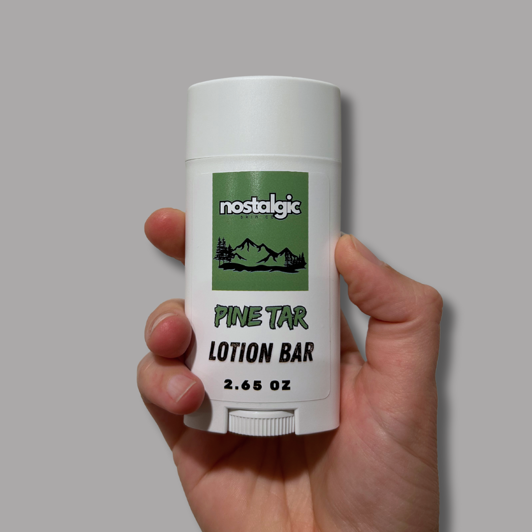 Pine Tar Lotion Bar held in hand, featuring organic ingredients and a protective packaging design.