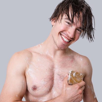 Man lathering Pine Tar soap in shower – rugged clean for working hands, natural lather.