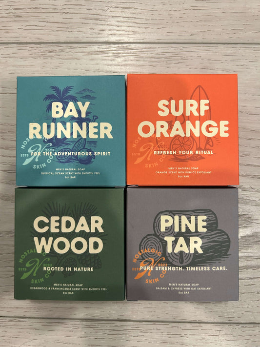 Dad Pack 4-Bar Natural Soap Gift Set including Bay Runner, Surf Orange, Cedarwood, and Pine Tar soaps on wooden surface
